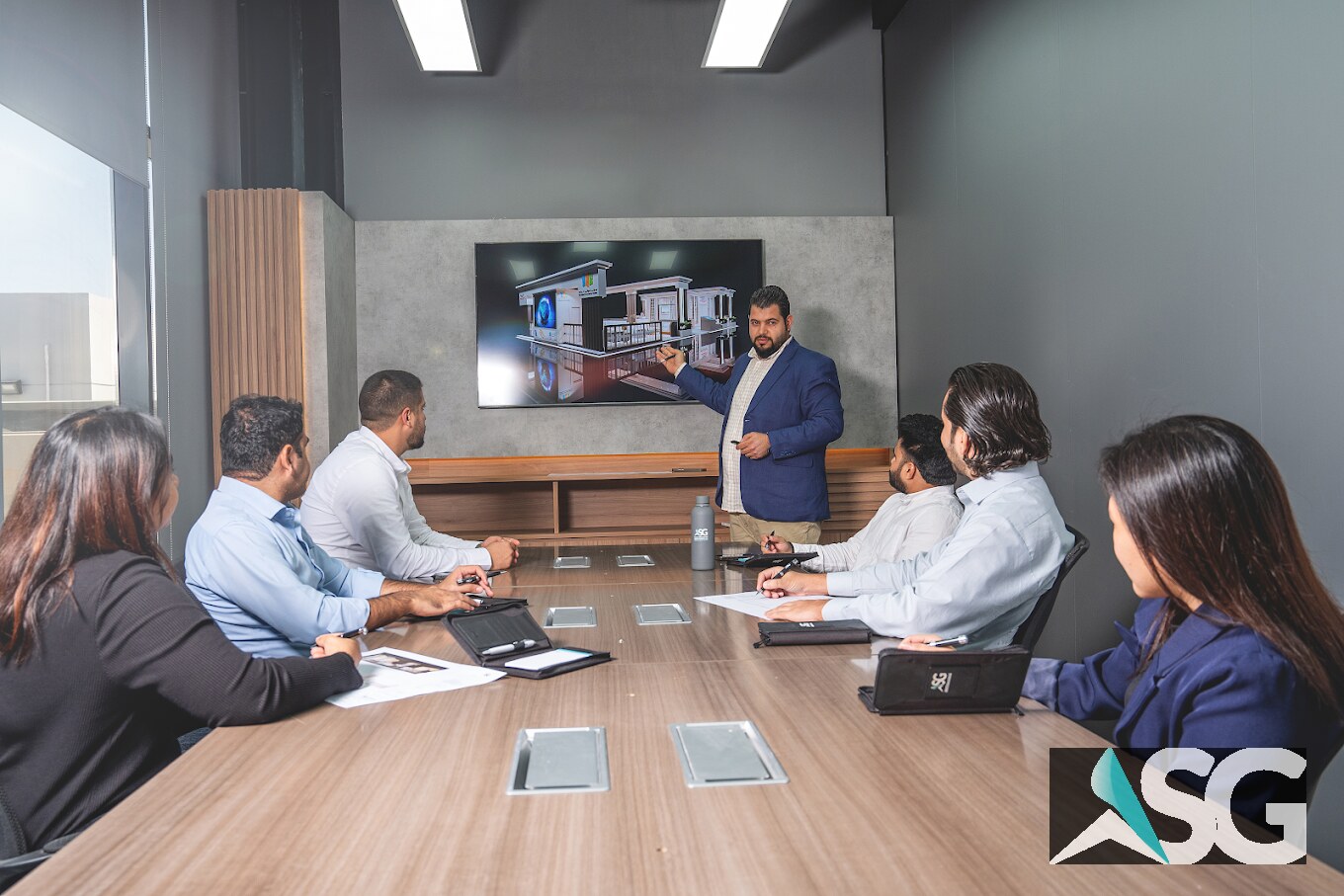 ASG team discussing an exhibition design presentation in a meeting room